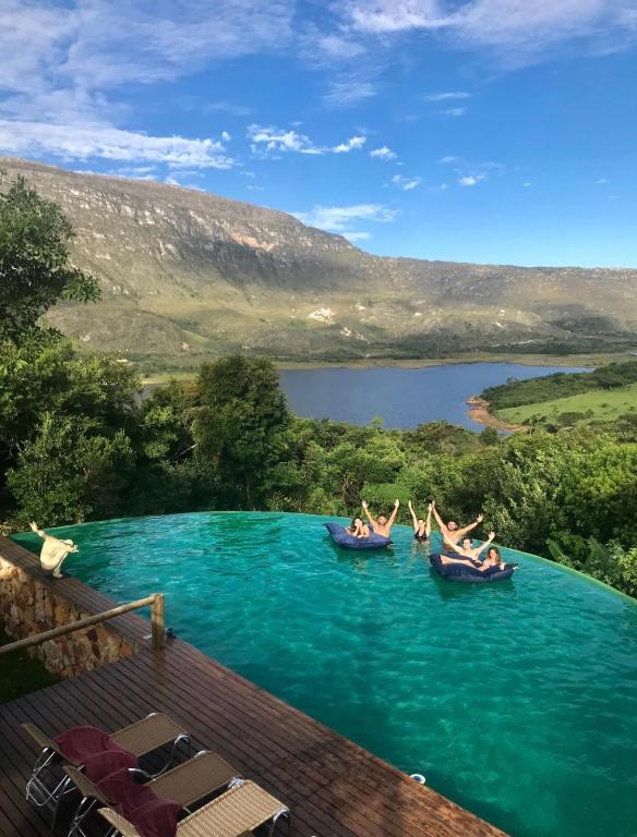 a group of people in boats in the water at Casa do Teuler - Lapinha da Serra in Santana do Riacho