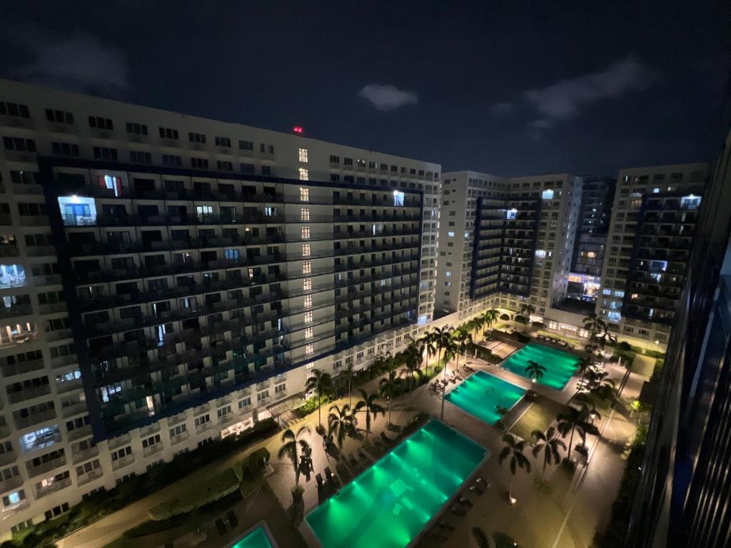 an aerial view of a large building at night at Sea Residences in Manila
