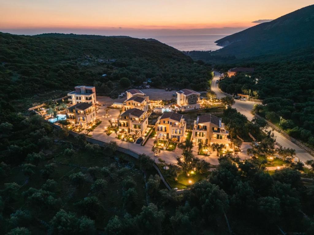 an aerial view of a mansion in the hills at night at Val D'or Olive Village in Ulcinj