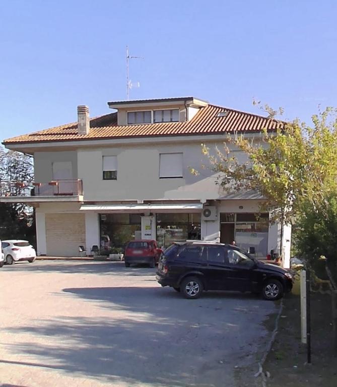 a black car parked in front of a building at B&B La Tenuta in Fermo