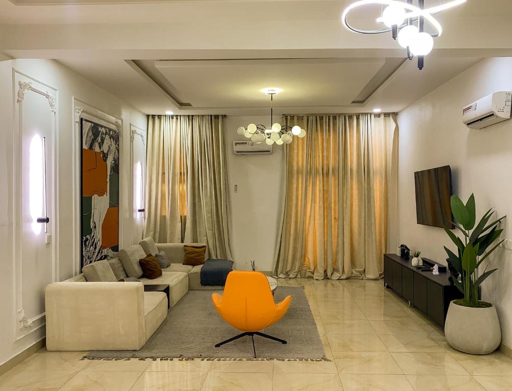 a living room with a couch and a chair at Super Star Midak Mews 2 in Lekki