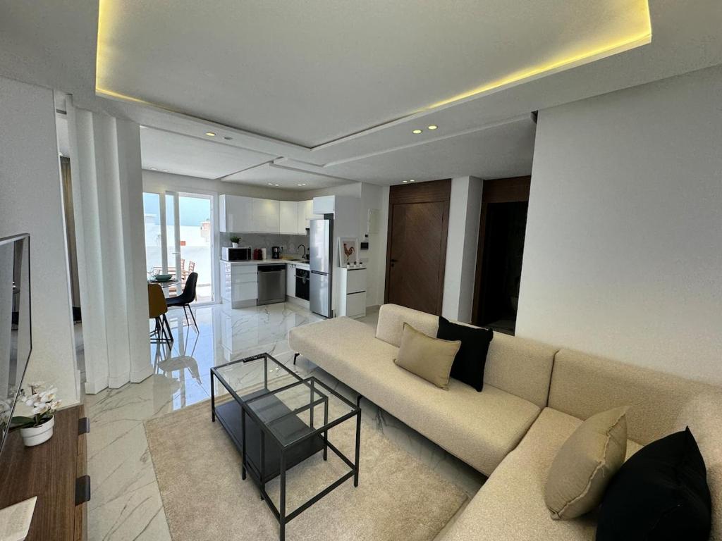 a living room with a couch and a table at Charming apt with terrace in Kenitra