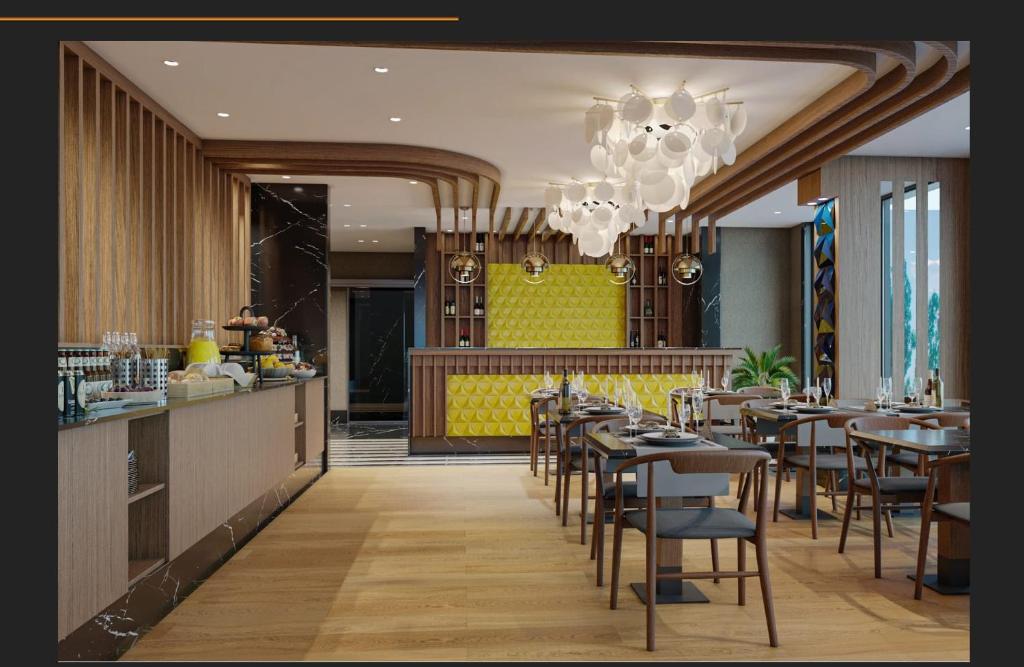 a restaurant with tables and chairs and a chandelier at Aspera Hotel Taksim in Istanbul