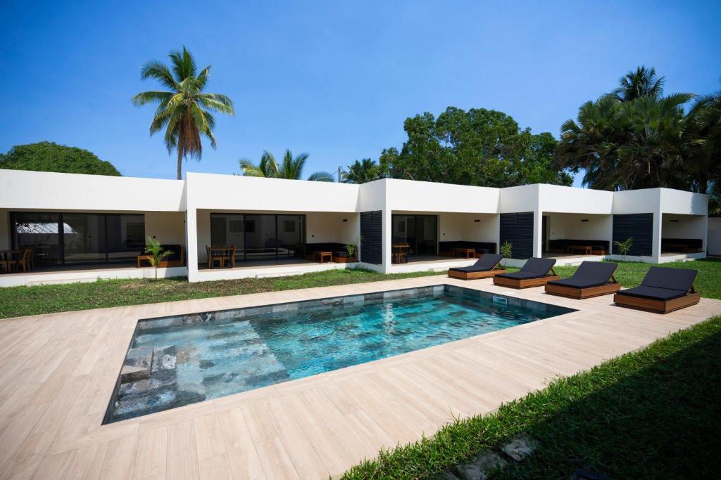 an exterior view of a house with a swimming pool at Villas 21 in Nosy Be