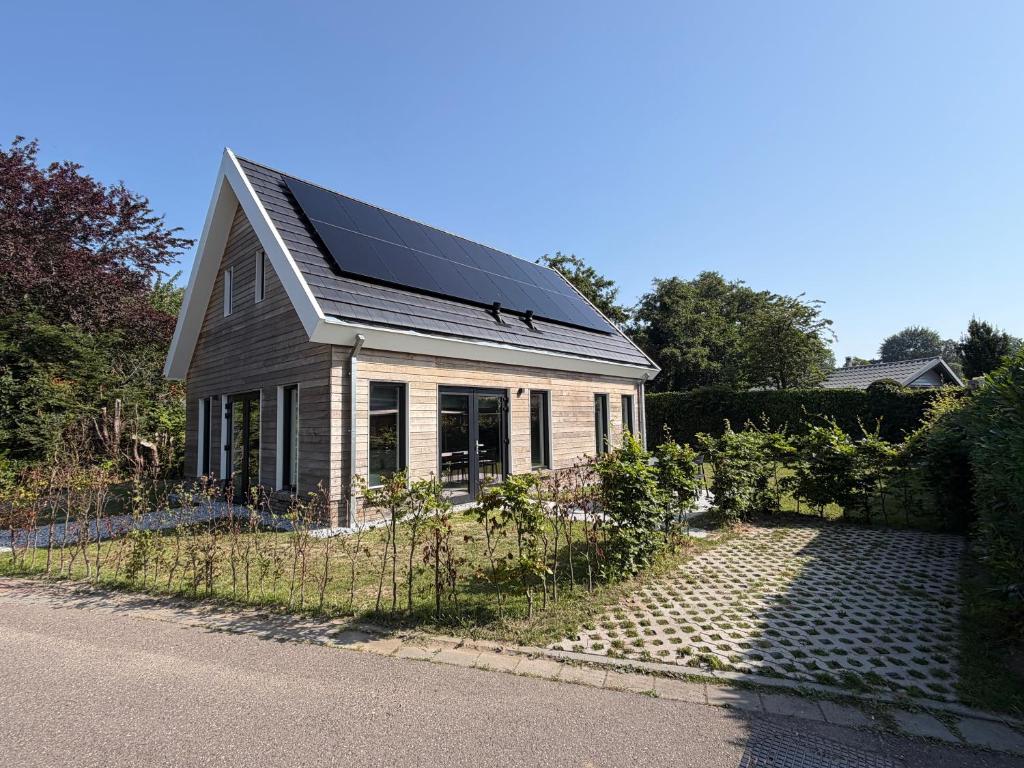 a house with a solar roof on the side of the road at Burgvliet41 in Oostkapelle