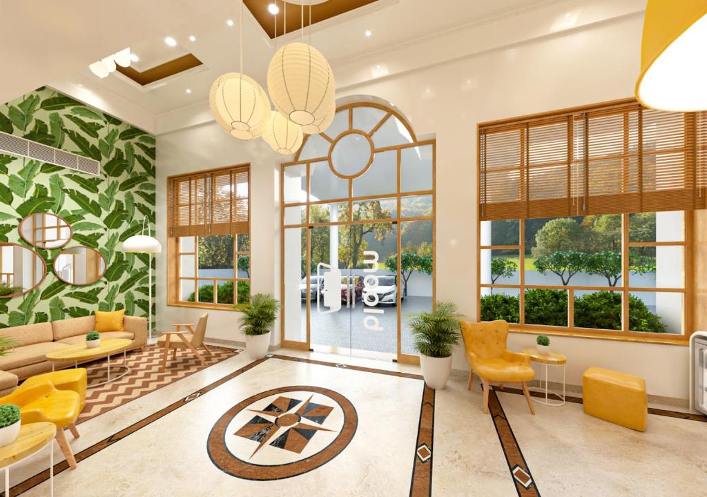a living room with a couch and a table and chairs at Bloom Hotel Chennai Central in Chennai