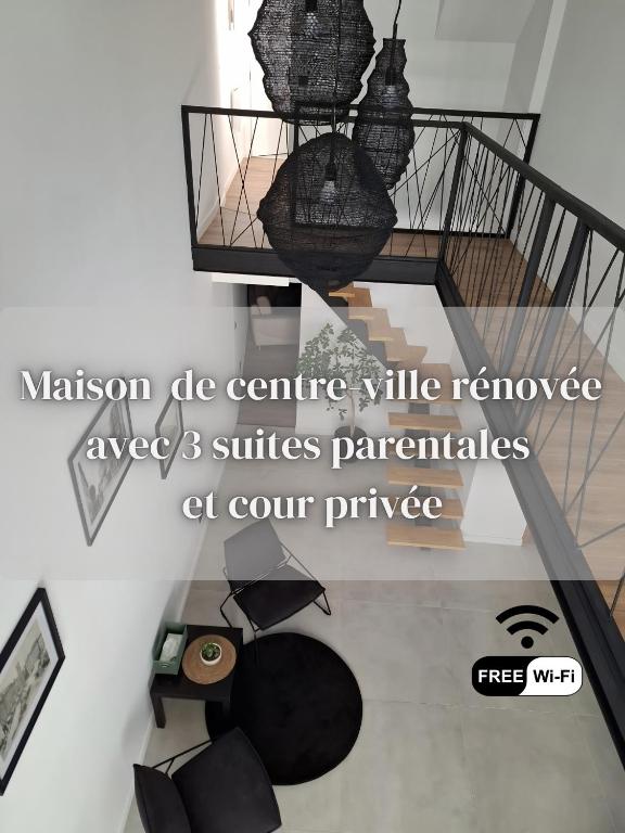 a picture of a staircase with a graduation cap hanging from a ceiling at Les 3 suites in Issoire