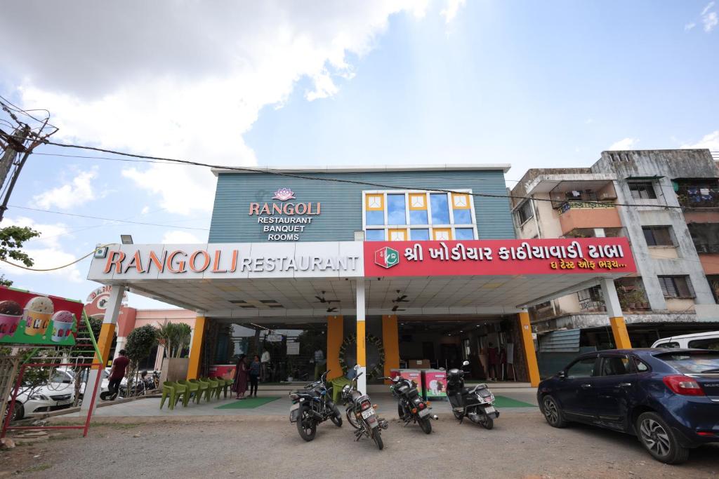 a group of motorcycles parked in front of a gas station at Hotel Rangoli Dharampur in Dharampur