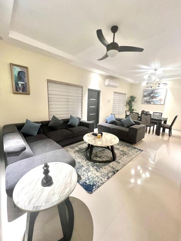 a living room with a couch and a table at ESEKK Ochi in Ocho Rios