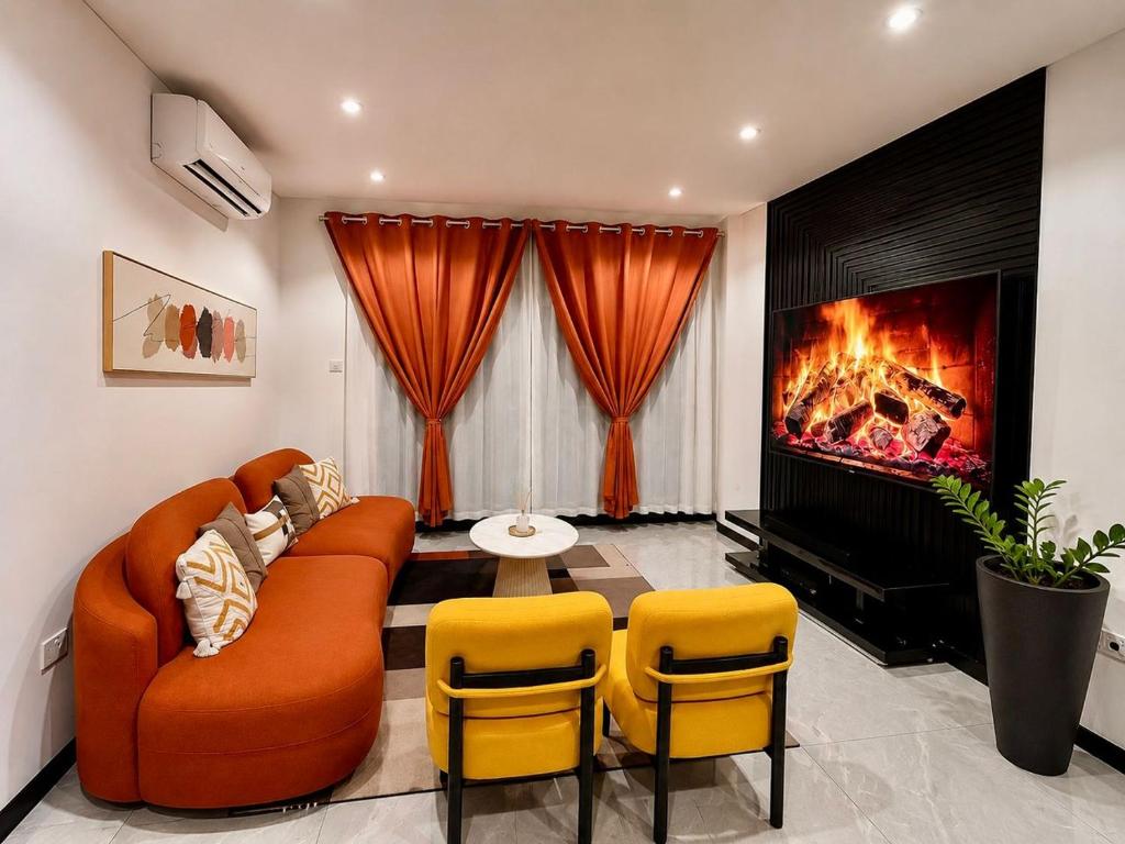 a living room with a couch and a fireplace at Platinum apartments in Gaborone