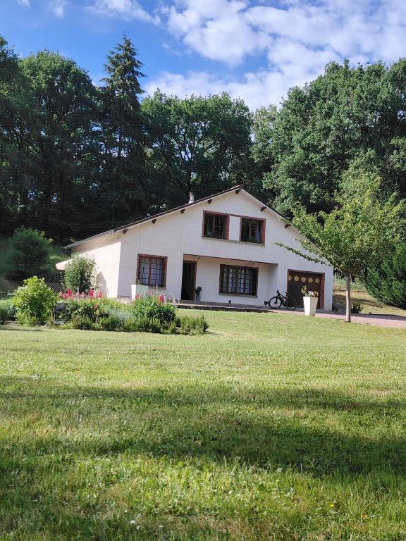 a white house in a field with a yard at L échappée verte in Gien