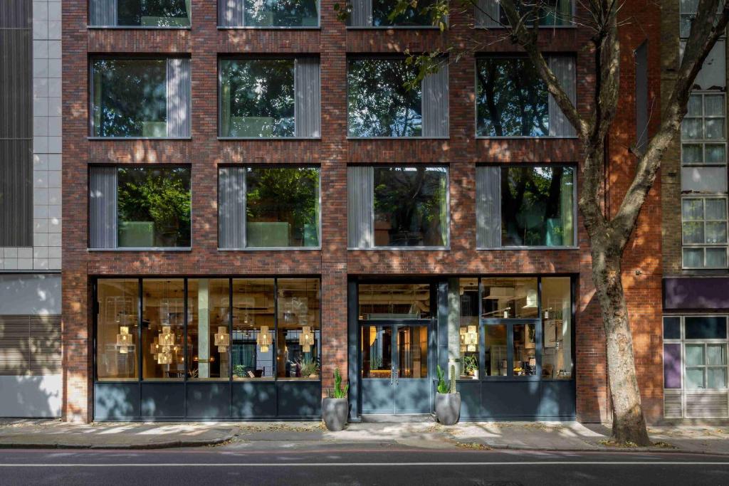 a brick building with many windows on a street at Bermonds Locke, Tower Bridge in London