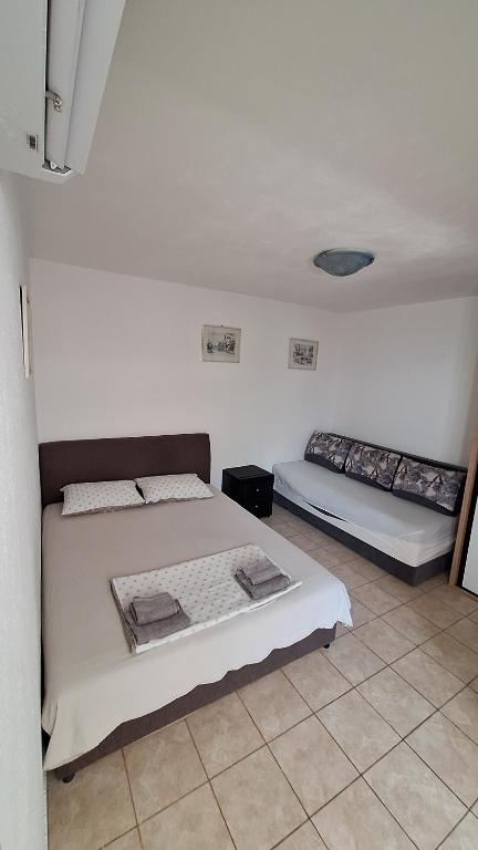 a bedroom with two beds in a room at rašo in Pržno