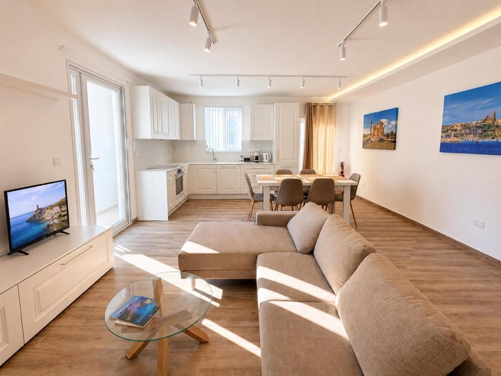 a living room with a couch and a table at Il Kenn ta Zeppi - Apartment 4 in Qala