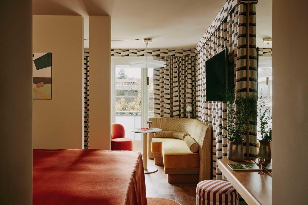 a living room with a couch and a chair at Locke am Platz Zurich in Zurich