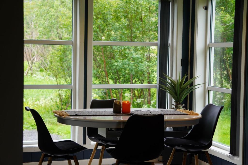 a table and chairs in front of a window at Panorama Valley Lofoten in Bøstad