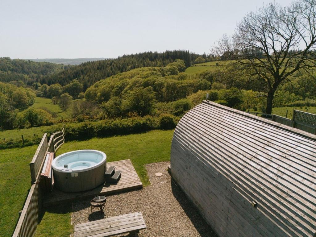 a bath tub sitting on top of a roof at Rivendell Farm Glamping in Carmarthen