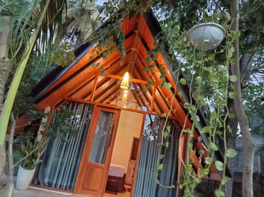 a house with a lot of plants around it at Sunset Dream Cabana in Tangalle