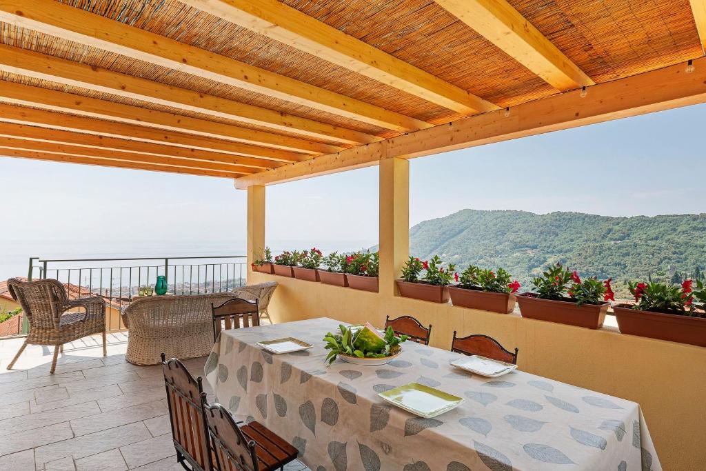 a table on a balcony with a view of the ocean at Pietra Viva in Poggio