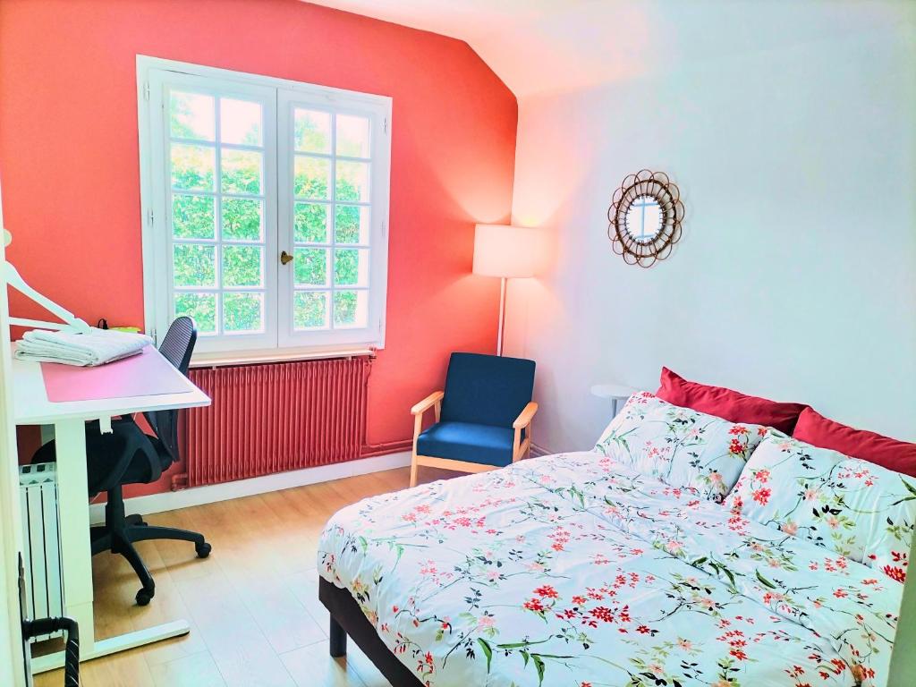 a bedroom with a bed and a desk and a window at Cottage de Vardes in Neufmarché