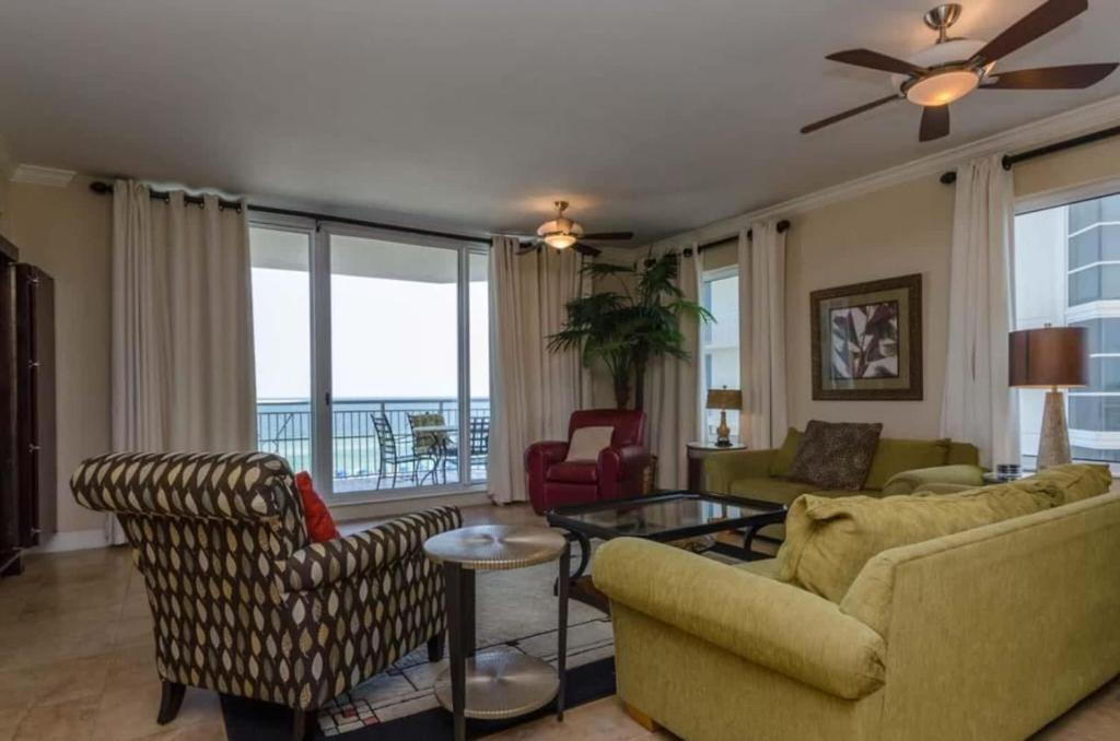 a living room with a couch and chairs and a table at Three Bedroom Corner Condo with Gulf View Balcony in Pensacola