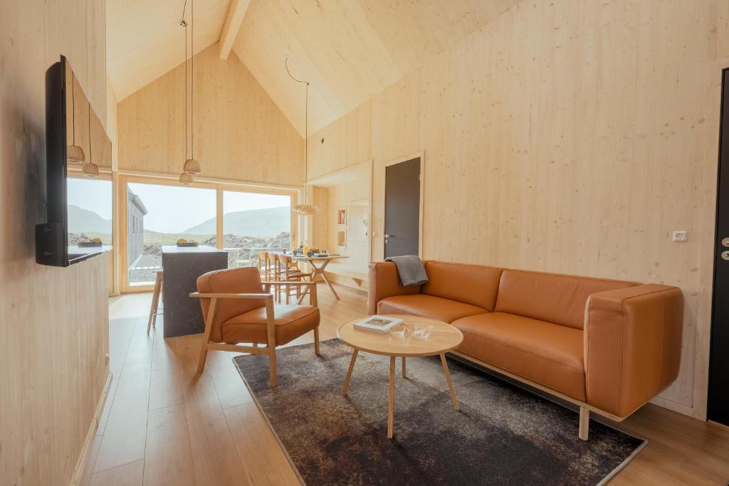 a living room with a couch and a table at The Lakehouse in Miðvágur