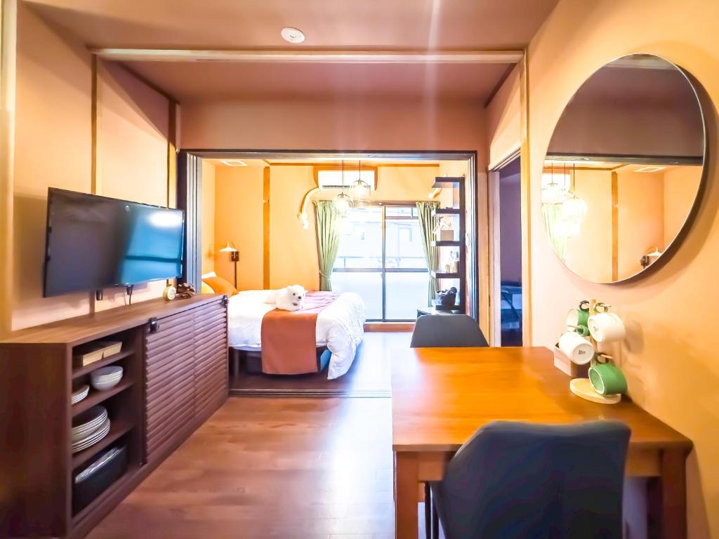 a bedroom with a bed and a large mirror at Meijo Mikan Stay in Nagoya
