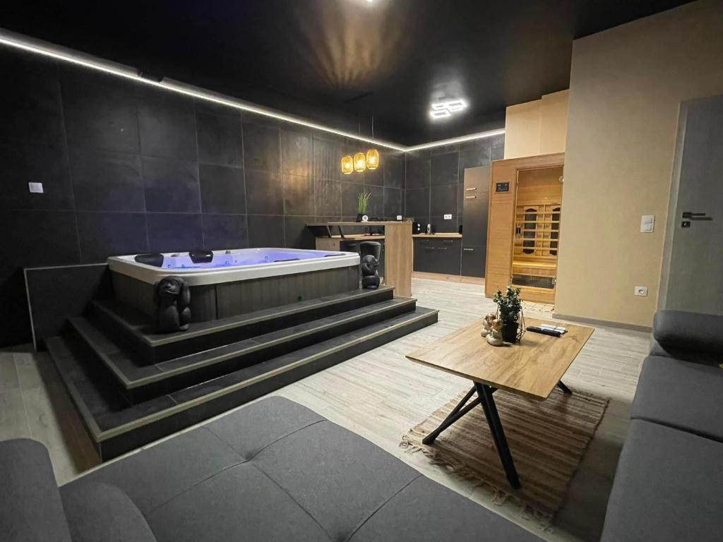 a large bathroom with a tub and a table at Ancram SPA Miskolc in Miskolc