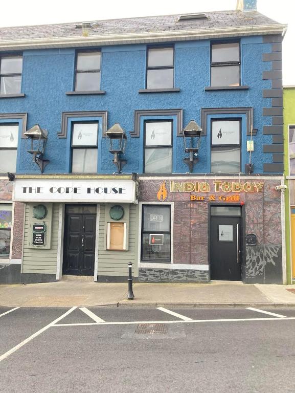 a blue building on the corner of a street at Cope House Rooms in Killybegs