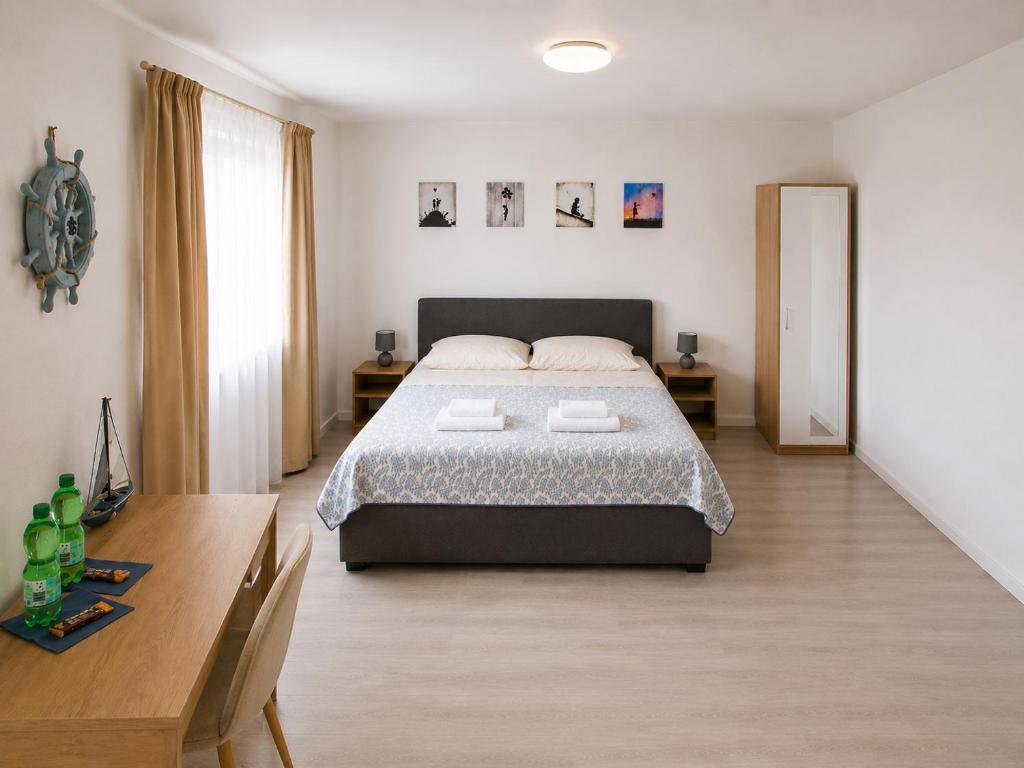 a bedroom with a large bed and a wooden table at Hotel am Seehafen in Hamburg
