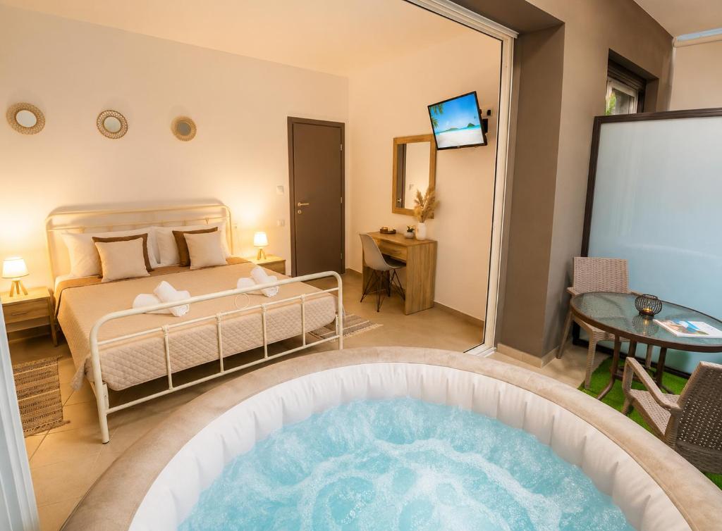 a hotel room with a bed and a tub at Maquestas Modern Apartments in Archangelos