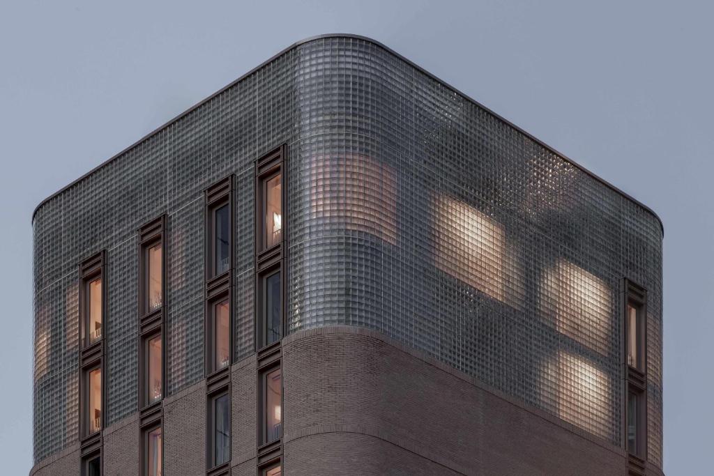 a brick building with the sun shining on it at Buckle Street Studios by Locke, Aldgate in London