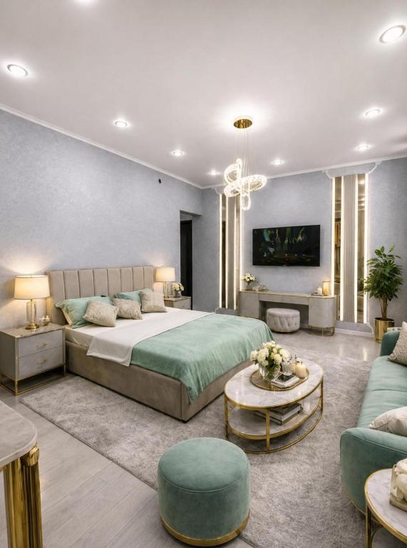 a bedroom with a large bed and a living room at Taraz 2 in Taraz