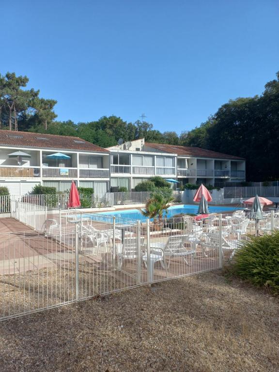a resort with a pool with chairs and umbrellas at Domaine jard mer in Jard-sur-Mer