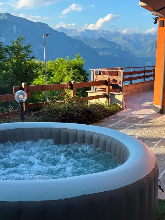 a hot tub with a view of the mountains at Casa Panorama Intelvi - Como & Lugano Lakes in Laino