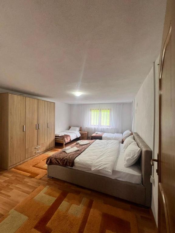 a bedroom with a large bed in a room at Albanica Guesthouse in Dacići