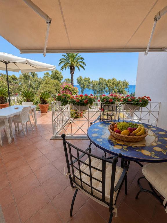 a table with a bowl of fruit on a patio at B&B L'ORIZZONTE in Crotone