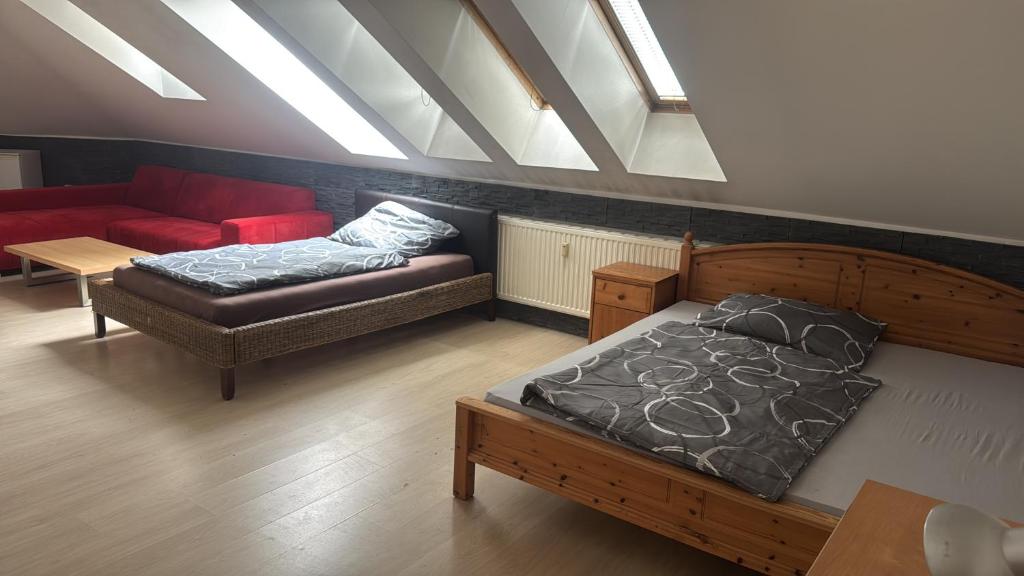 a bedroom with a bed and a couch and a table at Apartment47 in Amstetten