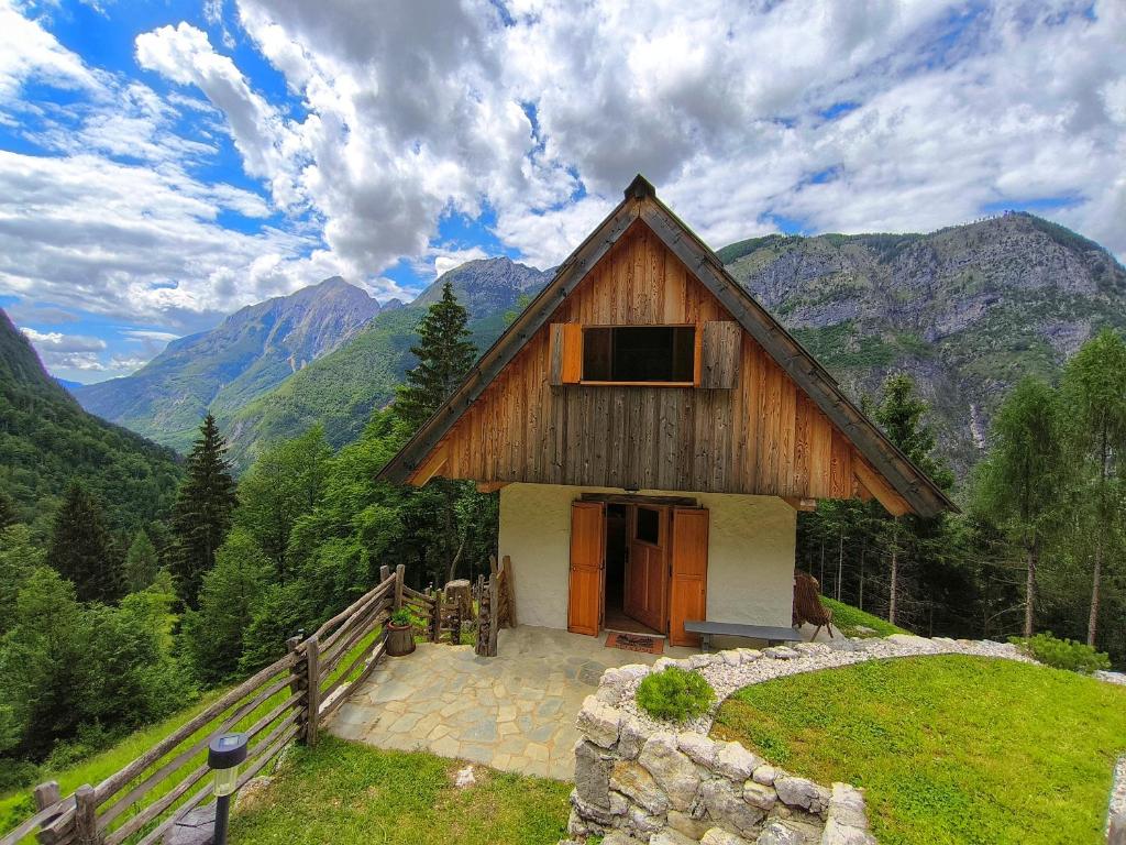 a wooden house in the middle of a mountain at Gorsko zavetje Cottage in Soča