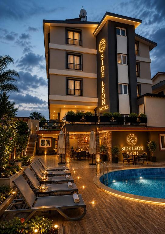 a hotel with a pool in front of a building at Green Side Leon Hotel in Side