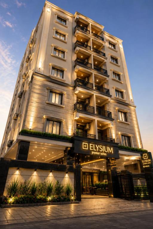 a tall building with a sign in front of it at ELYSIUM Premier Suites Hitec City in Hyderabad
