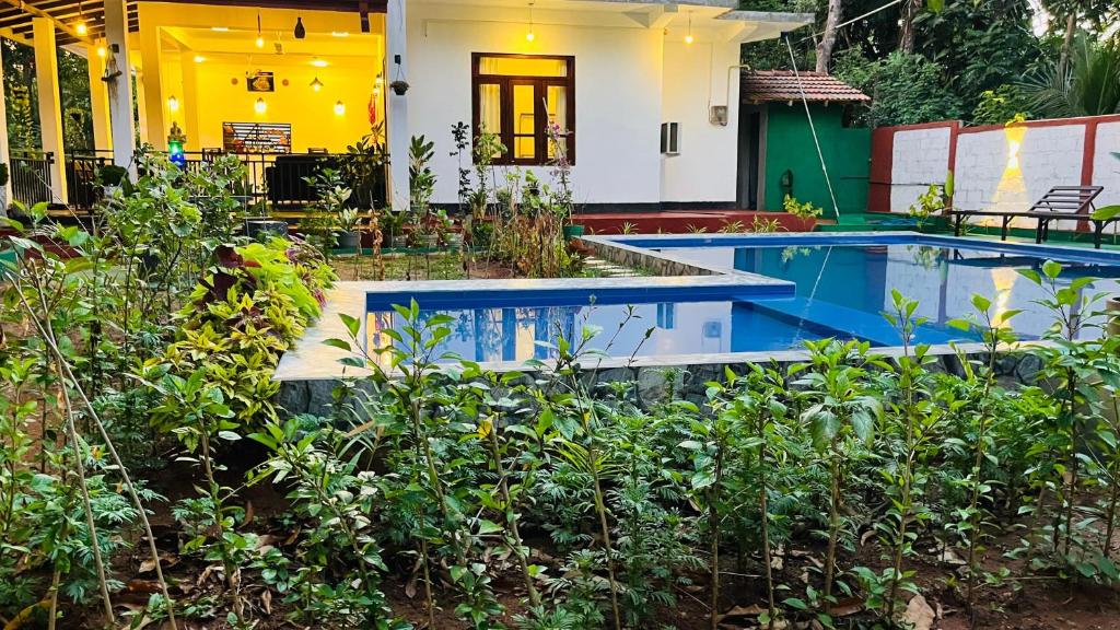 a house with a swimming pool in a garden at Shaa Home Stay Sigiriya in Sigiriya