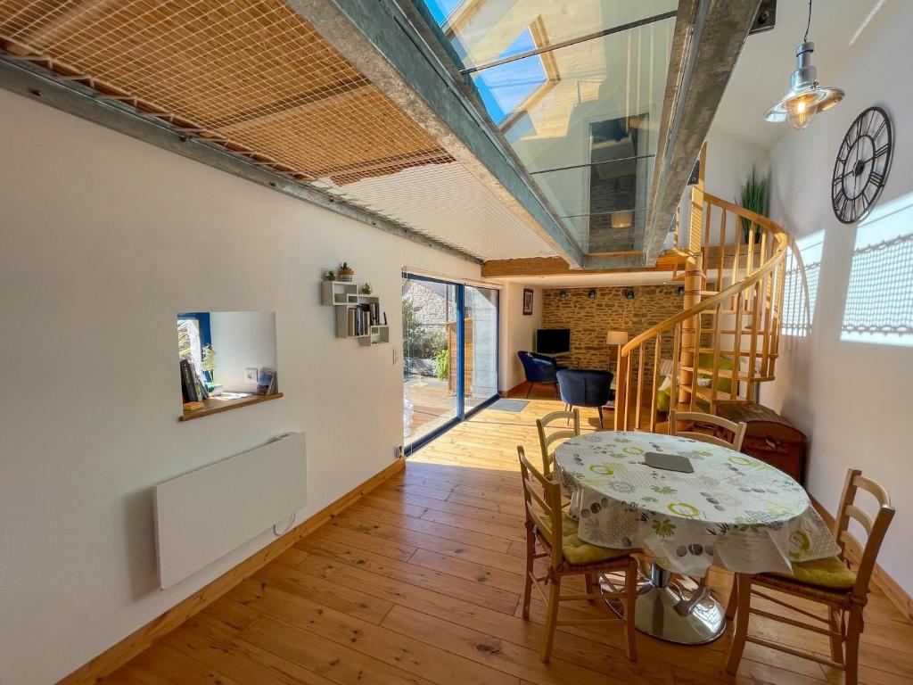 a kitchen and dining room with a table and chairs at Ty Heole House in Plouézec