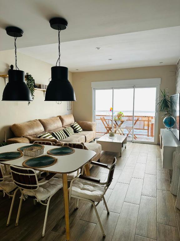 a living room with a table and a couch at Casa Roa in Altea