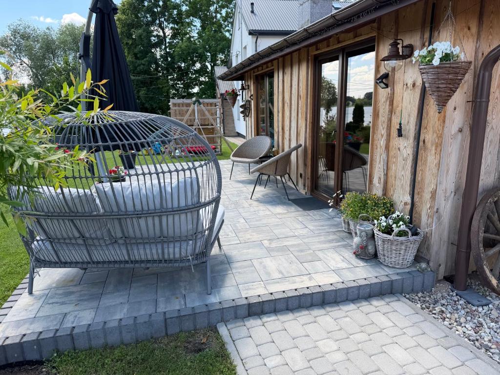 a patio with a chair and an umbrella at Pokoje Gościnne Nad Jeziorem in Rajgród
