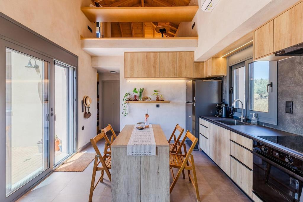 a kitchen with a table and chairs in a kitchen at Terra Rossa in Plytra