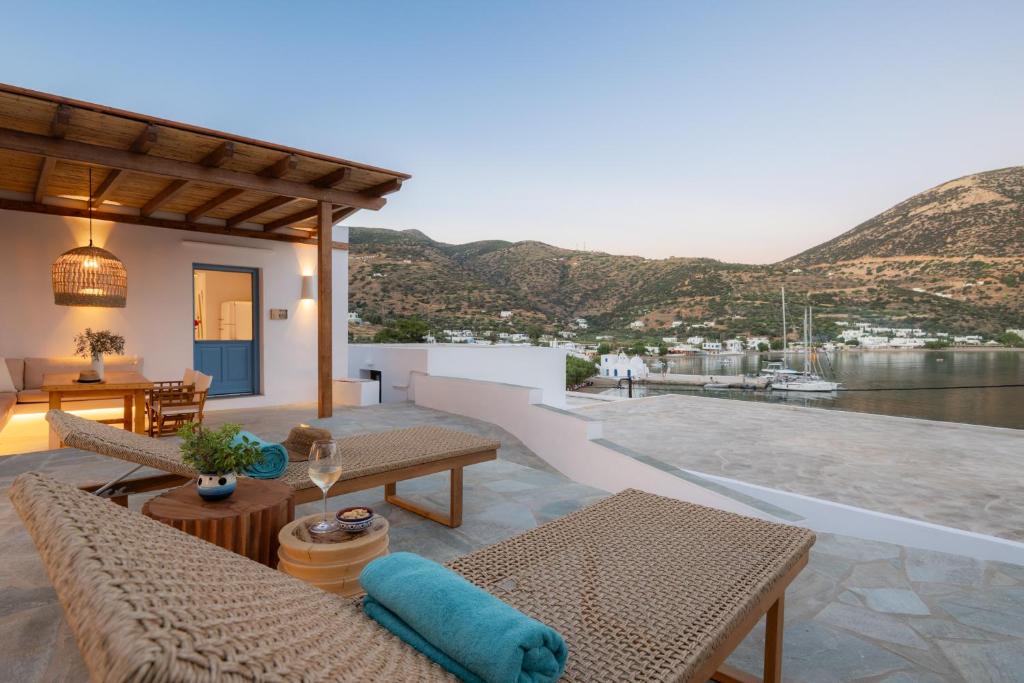 a house with a patio with a view of the water at Archipelago Sifnos - Seaside Accommodation in Vathi