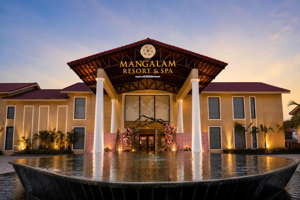 a building with a clock on the front of it at Mangalam Resort & Spa - Member of Absolute Collection in Aurangabad