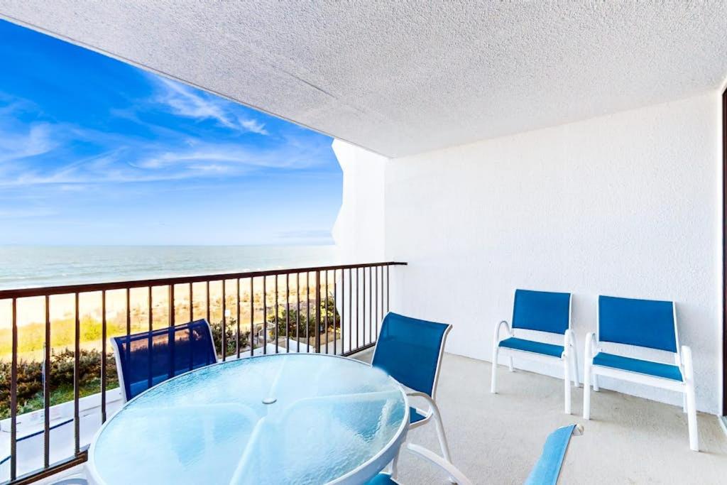 a table and chairs on a balcony with the ocean at Pyramid 4G in Ocean City