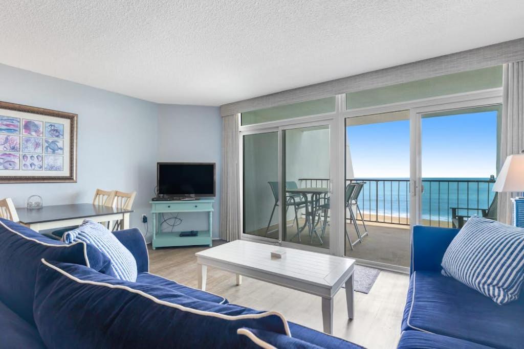 a living room with a blue couch and a view of the ocean at Pyramid 5C in Ocean City